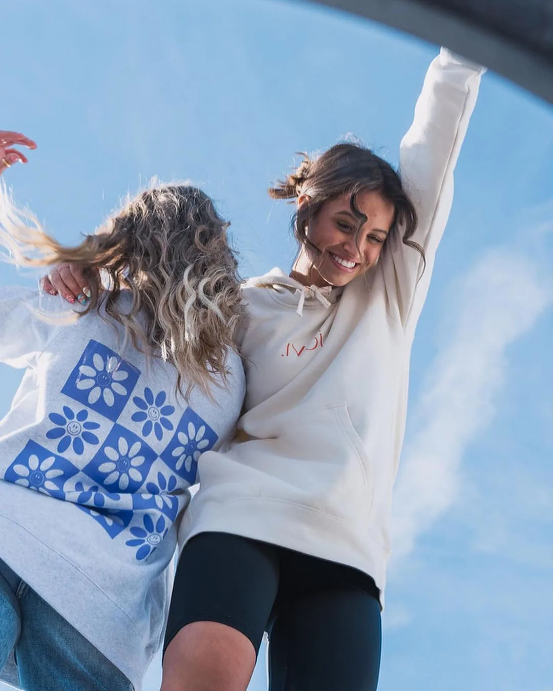 Models in Jovi merch against the sky