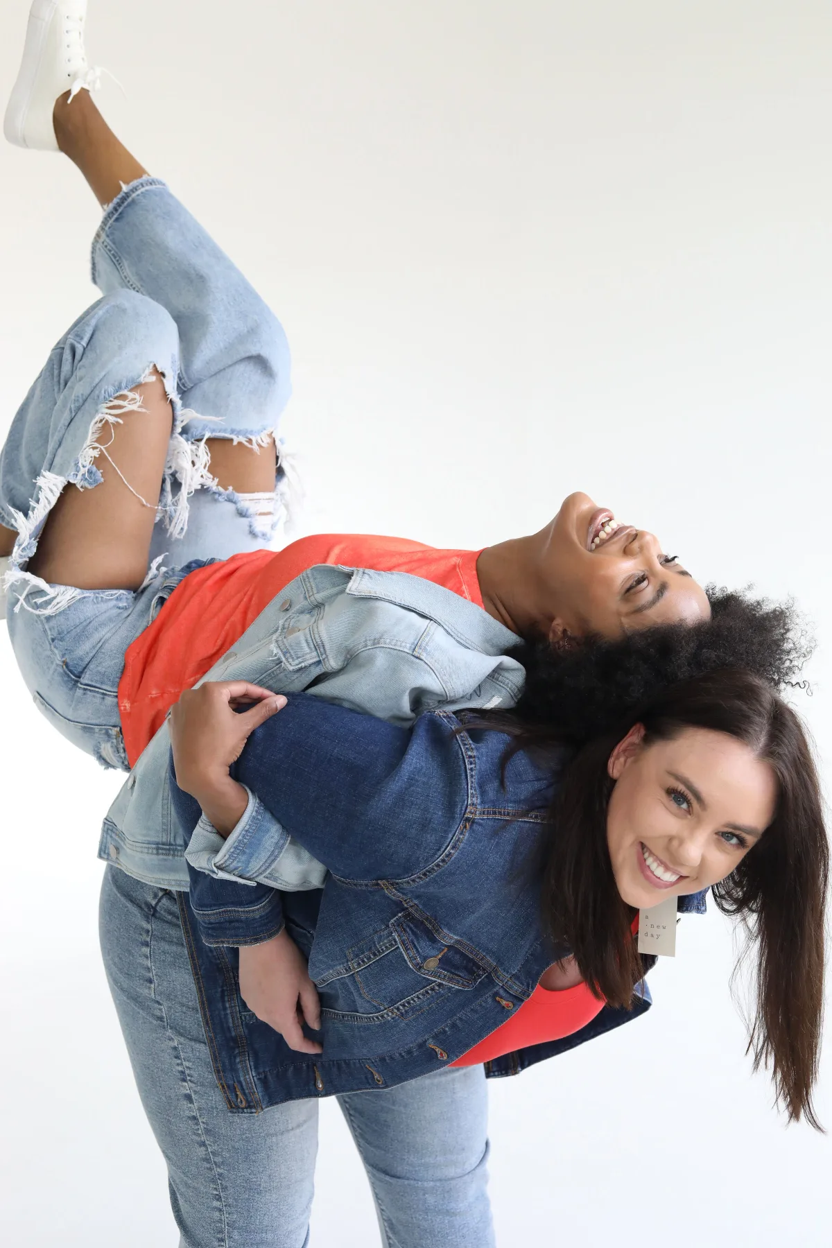Two models laughing in denim