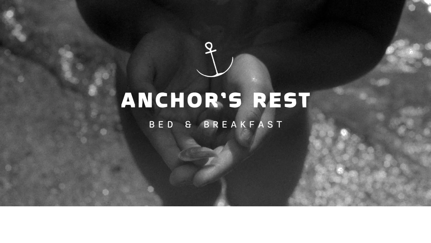 Logo over black-and-white shoreline photography