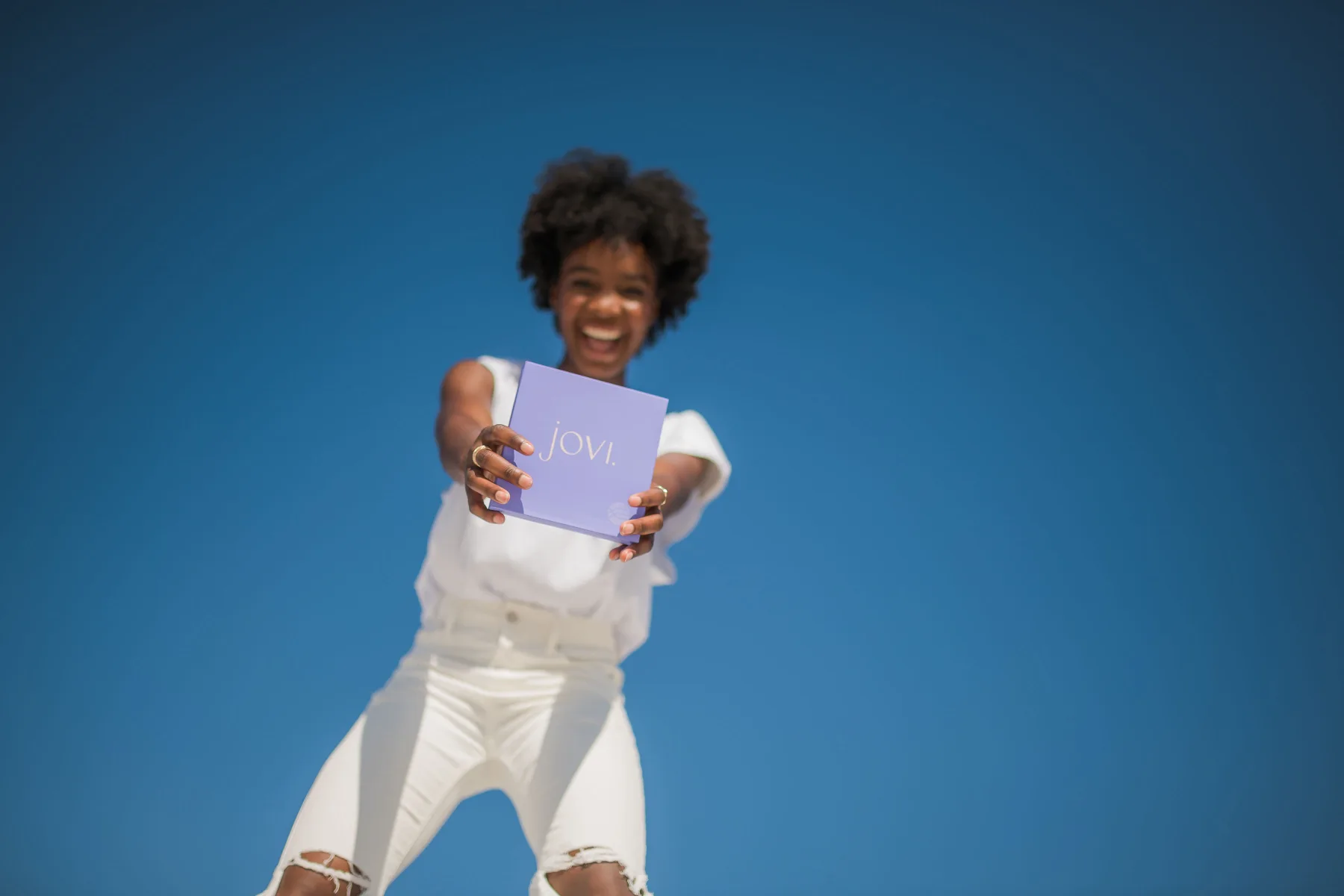 Model holding Jovi box
