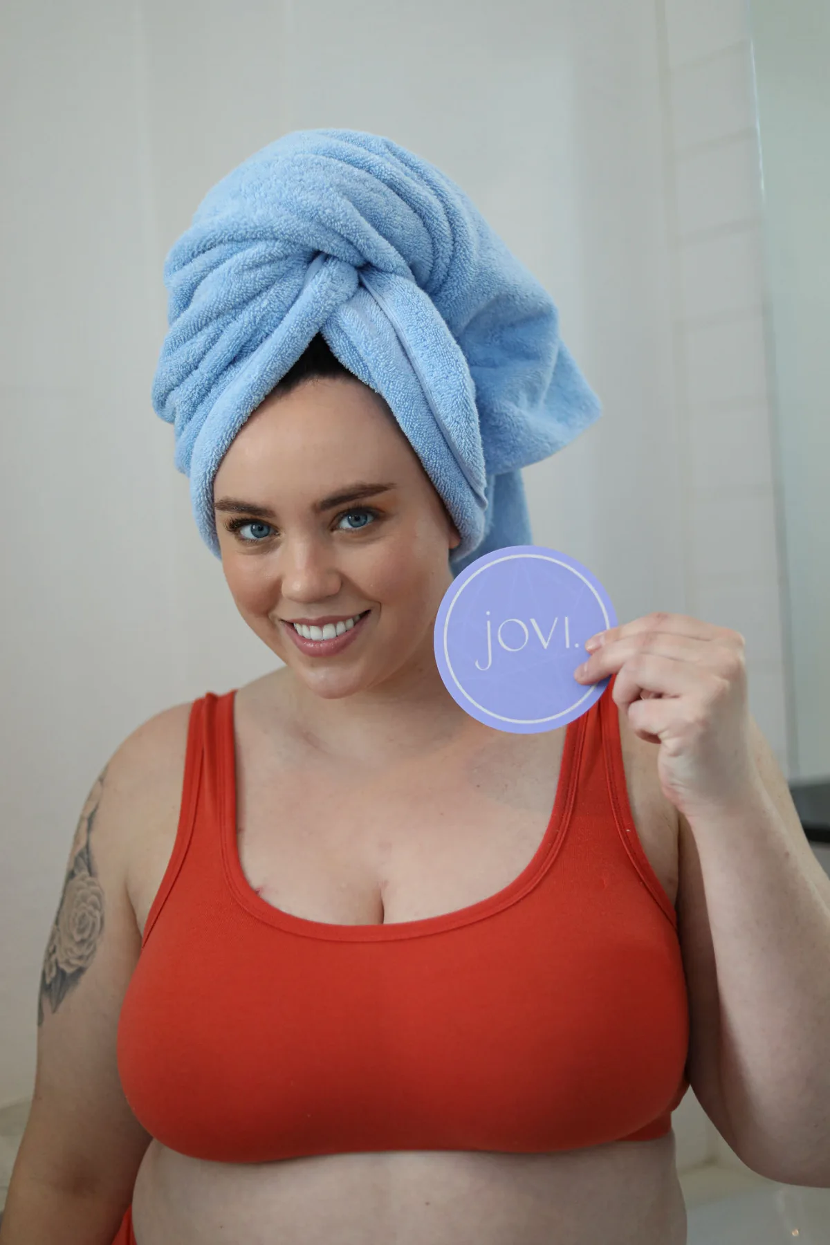 Model smiling with towel wrap and coaster