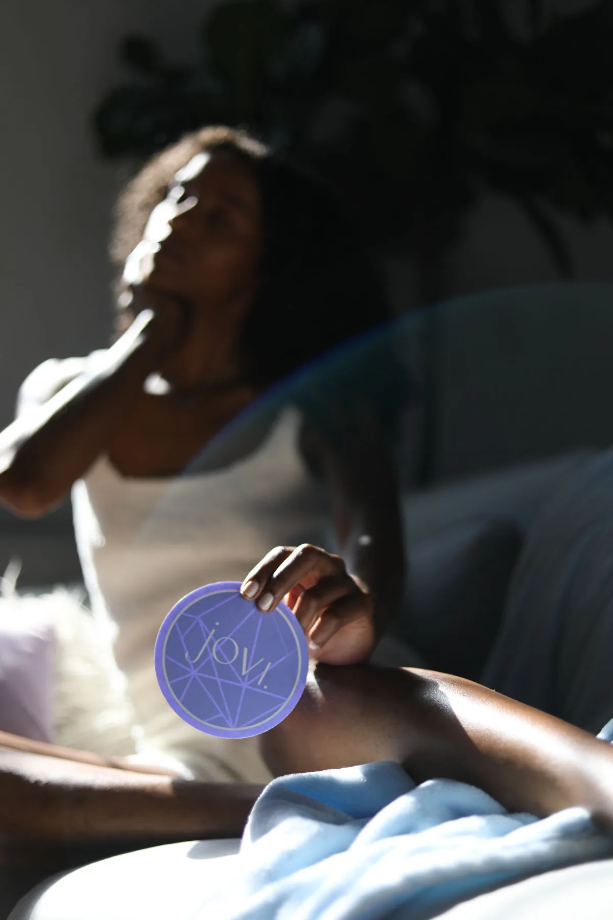 Coaster held up in a sunlit room